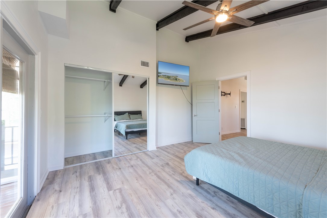 132 Zenna Drive Mathis, TX 78368 - Photo 15 of 40 a bedroom with a bed and a flat screen tv