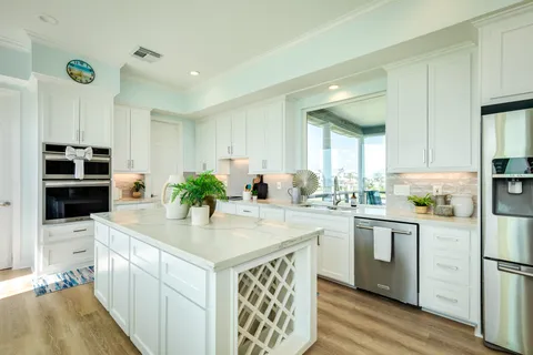 a kitchen with stainless steel appliances kitchen island granite countertop a sink and cabinets