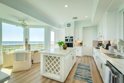 a large white kitchen with a large window