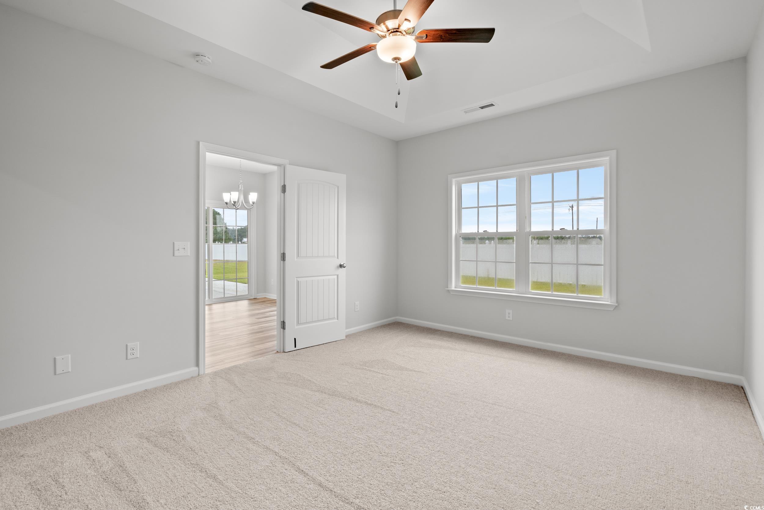 267 Stillbrook Drive Longs, SC 29568 - Photo 11 of 37 Spare room featuring a raised ceiling, light colored carpet, and healthy amount of natural light