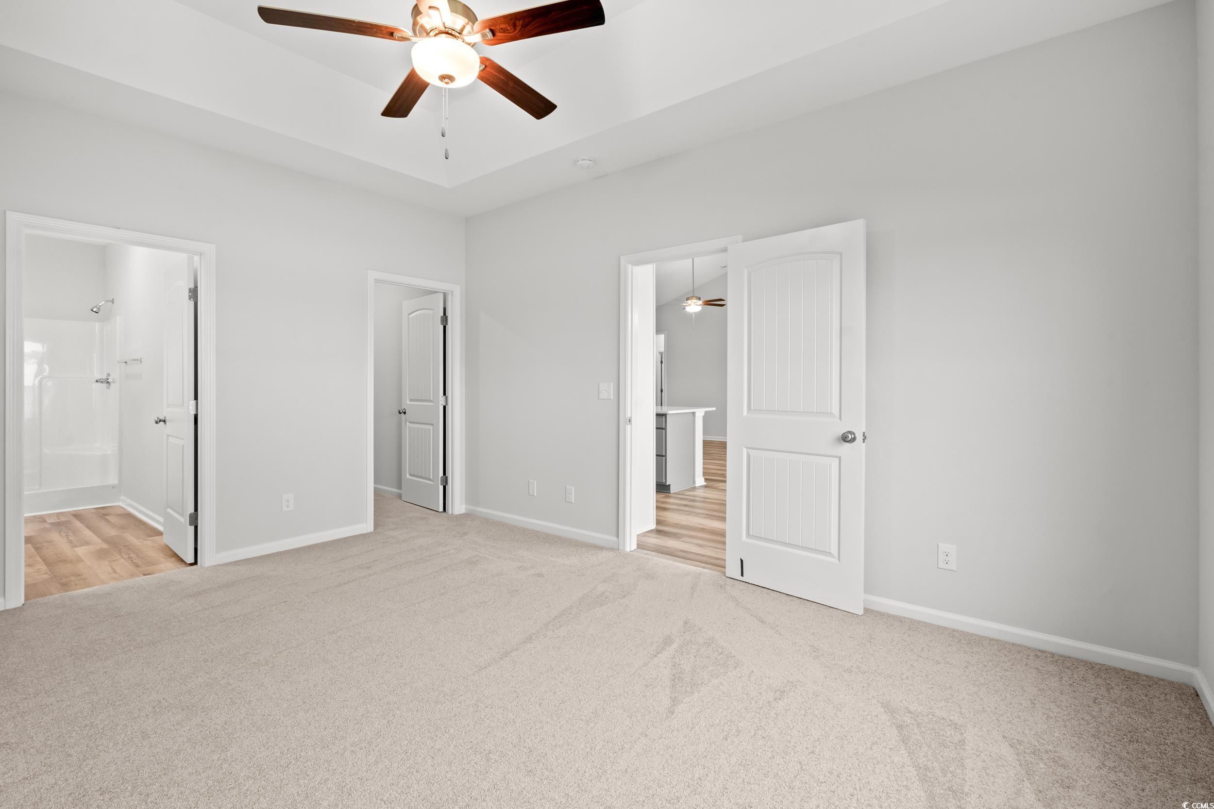 267 Stillbrook Drive Longs, SC 29568 - Photo 12 of 37 Unfurnished bedroom featuring light carpet, ceiling fan, and ensuite bathroom
