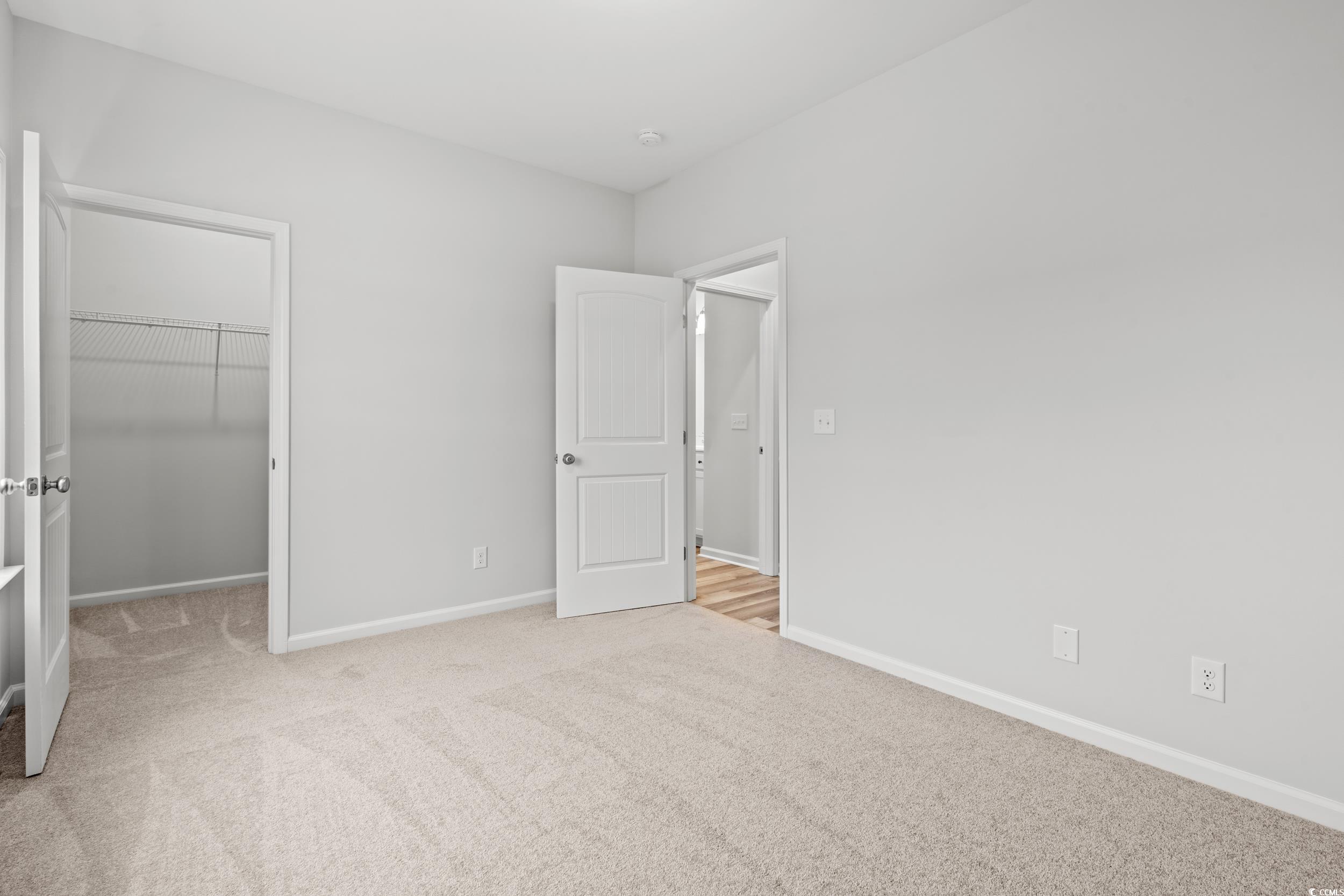 267 Stillbrook Drive Longs, SC 29568 - Photo 17 of 37 Unfurnished bedroom featuring light colored carpet and a walk in closet
