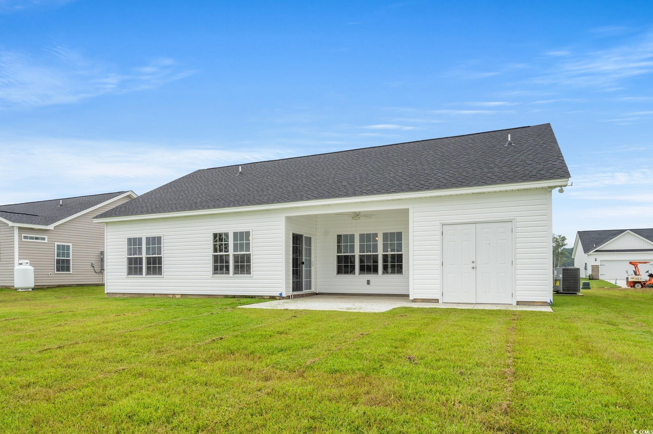 267 Stillbrook Drive Longs, SC 29568 - Photo 20 of 37 Back of house featuring a patio area, a yard, and roof with shingles