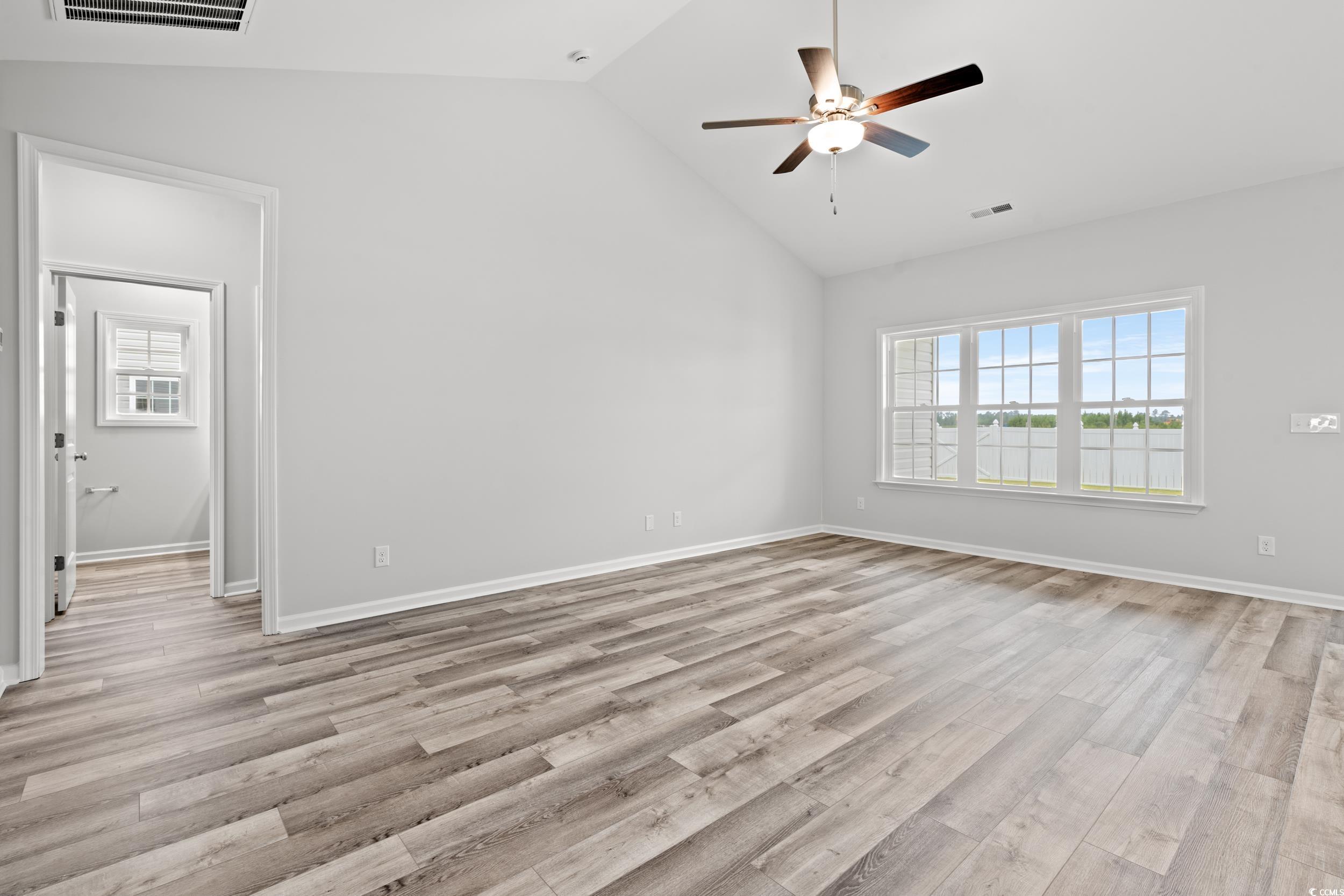 267 Stillbrook Drive Longs, SC 29568 - Photo 3 of 37 Unfurnished bedroom featuring light wood-type flooring, ceiling fan, and high vaulted ceiling