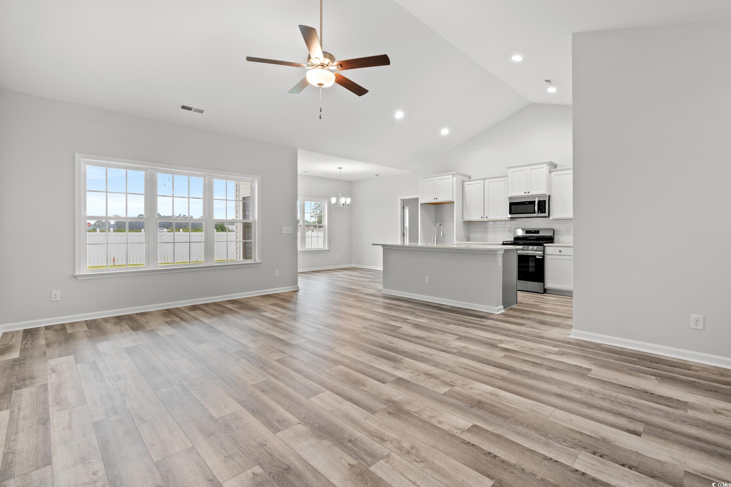 267 Stillbrook Drive Longs, SC 29568 - Photo 4 of 37 Unfurnished living room with ceiling fan, high vaulted ceiling, a chandelier, light wood-type flooring, and recessed lighting