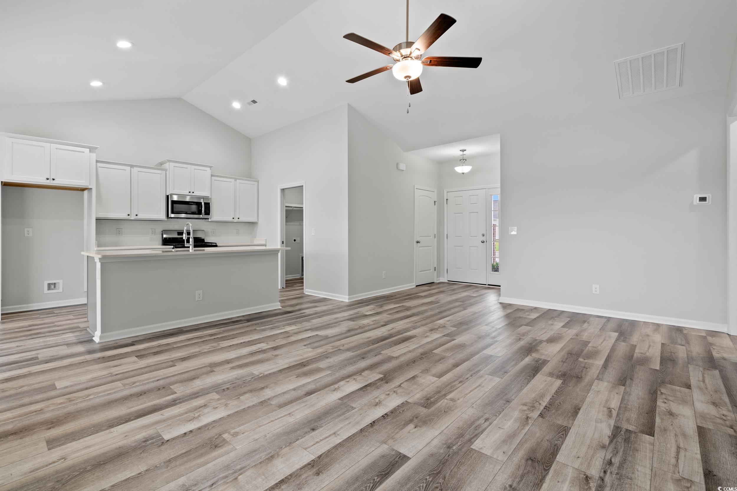 267 Stillbrook Drive Longs, SC 29568 - Photo 6 of 37 Unfurnished living room featuring light wood finished floors, high vaulted ceiling, and ceiling fan