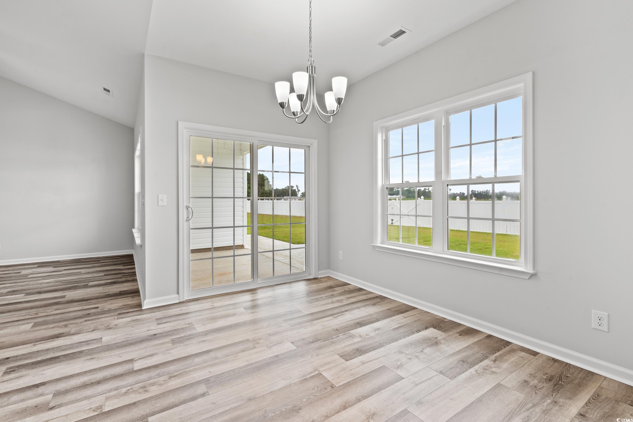 267 Stillbrook Drive Longs, SC 29568 - Photo 8 of 37 Unfurnished dining area with light wood-style floors and a chandelier