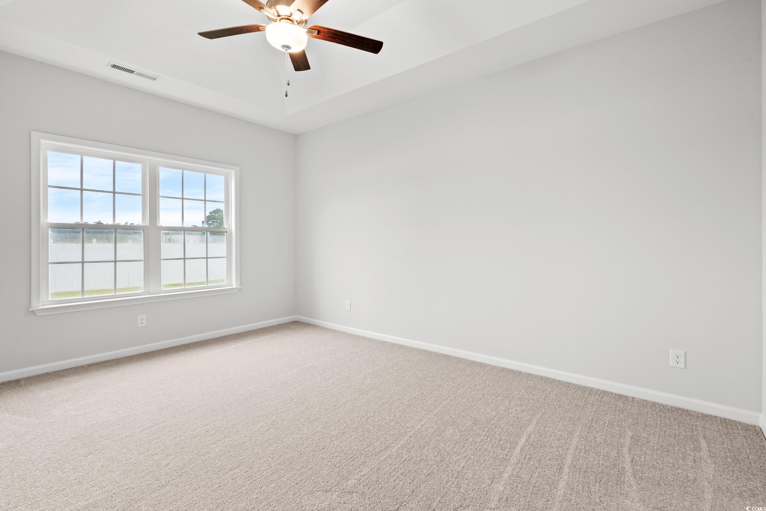 267 Stillbrook Drive Longs, SC 29568 - Photo 9 of 37 Carpeted empty room featuring a water view and a ceiling fan