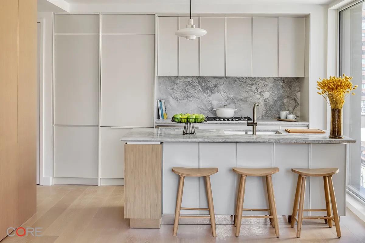 a kitchen with stainless steel appliances a sink and cabinets