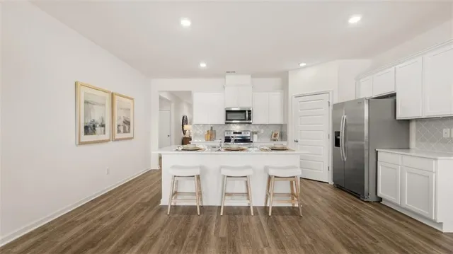 a kitchen with granite countertop a stove and a microwave