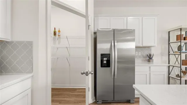a kitchen with sink wooden floor and glass door