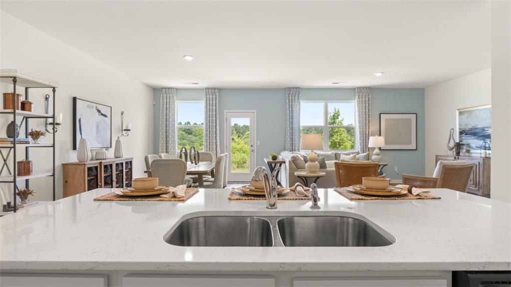 207 Cattle Drive Perry, GA 31069 - Photo 15 of 52 a kitchen with sink wooden floor and glass door