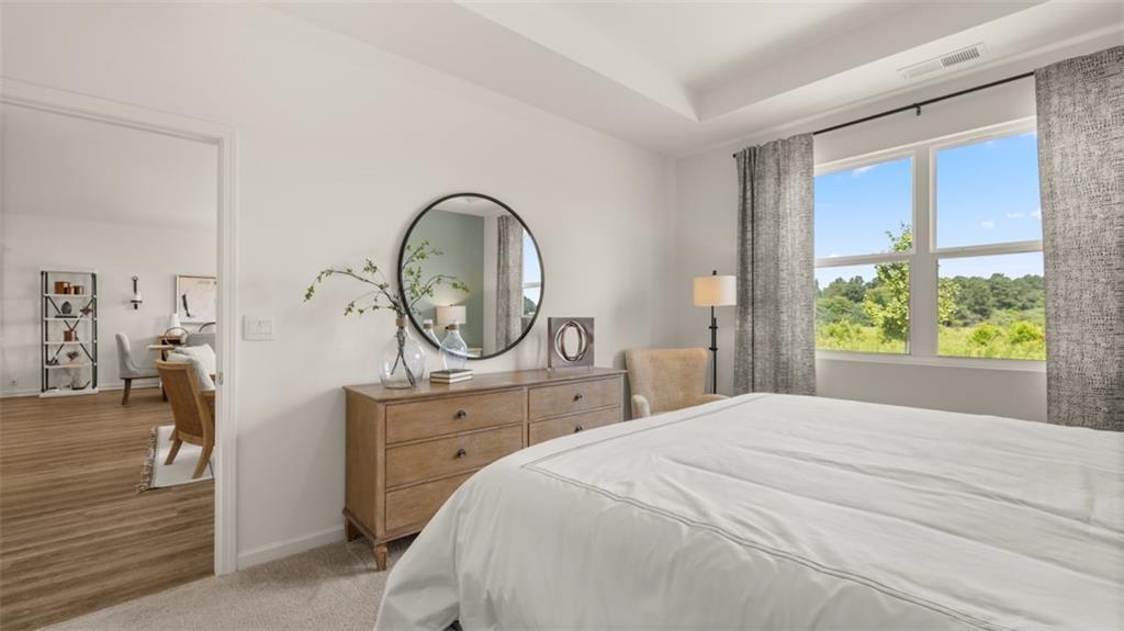 207 Cattle Drive Perry, GA 31069 - Photo 20 of 52 a bedroom with a bed a mirror on the dresser and a window