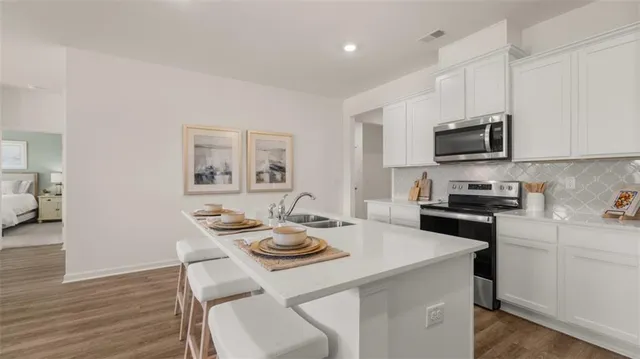 a kitchen with a stove a sink and a refrigerator