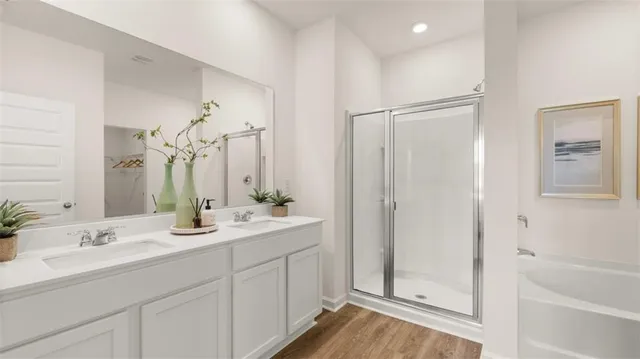 a bathroom with double vanity sinks a vanity and a mirror