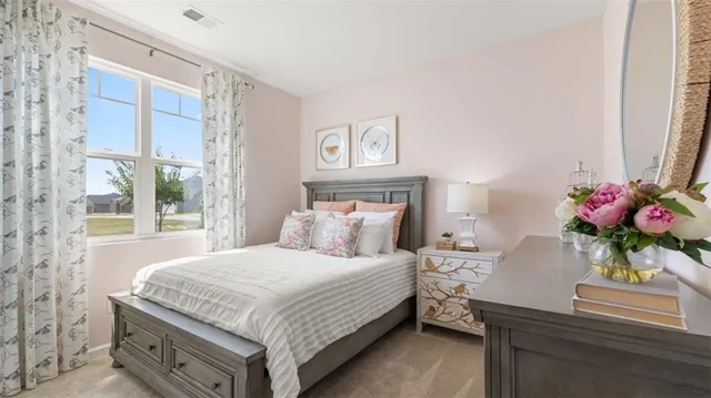 a bedroom with a bed and a dresser