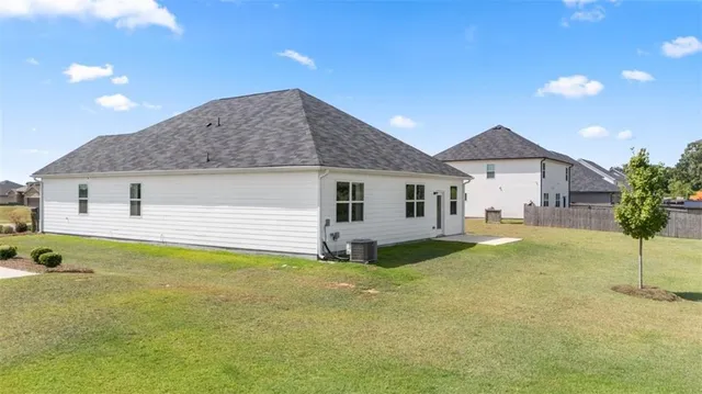 a view of a house with a backyard and porch