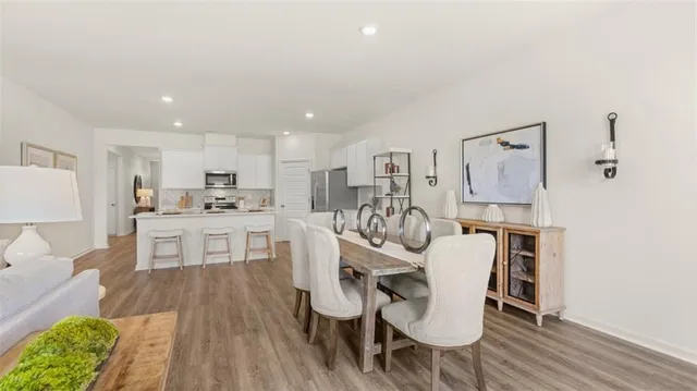 a view of a dining room with furniture window and wooden floor