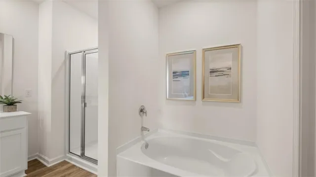 a bathroom with double vanity and a mirror