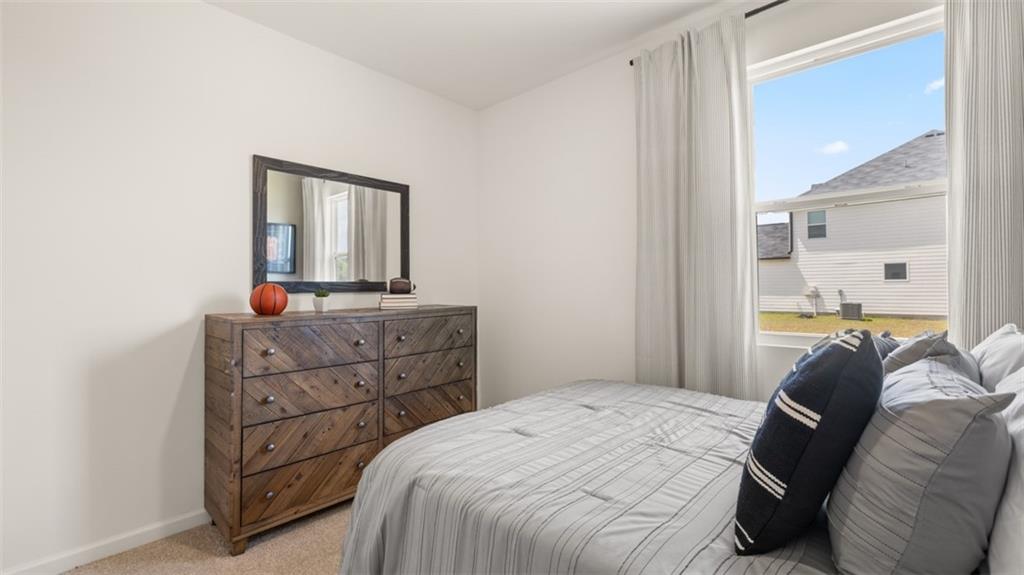 207 Cattle Drive Perry, GA 31069 - Photo 47 of 52 a bedroom with a bed and a mirror