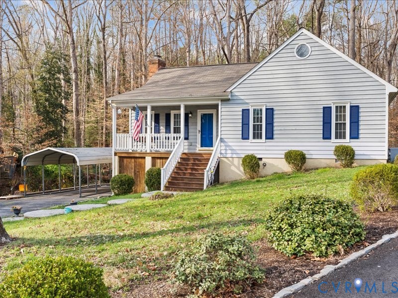 Ranch-style home with a front yard, covered porch,