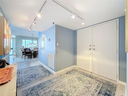 a hallway with wooden floor and furniture