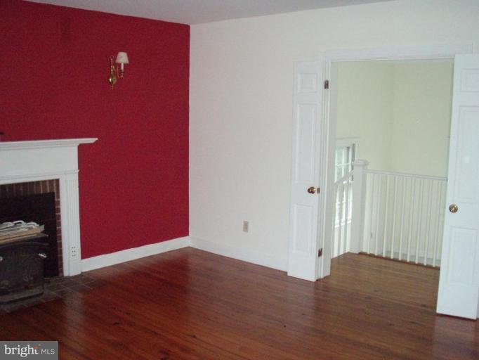 487 Rudasill Mill Road Woodville, VA 22749 - Photo 19 of 30 a view of a livingroom with wooden floor and a fireplace