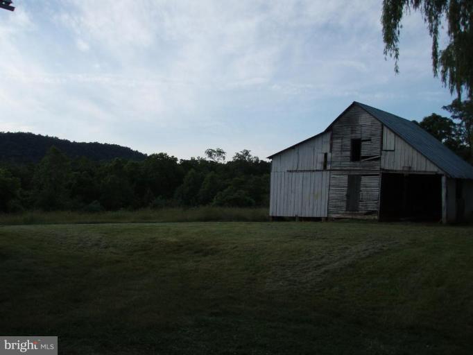 487 Rudasill Mill Road Woodville, VA 22749 - Photo 6 of 30 a view of a big house with a big yard