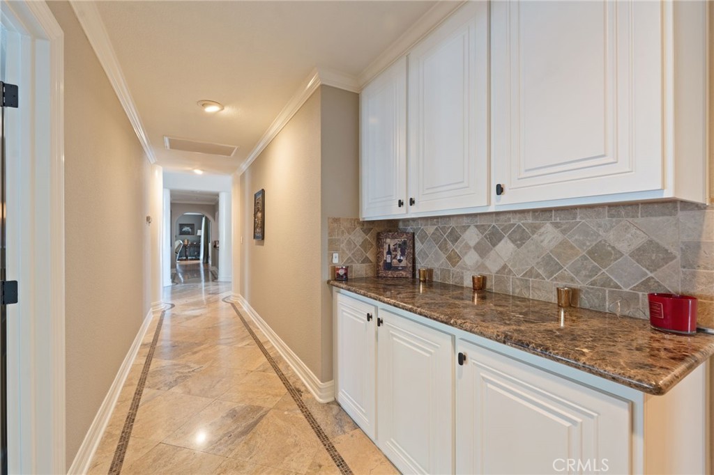 10588 Silver Spur Court Rancho Cucamonga, CA 91737 - Photo 27 of 63 a kitchen with granite countertop white cabinets and sink