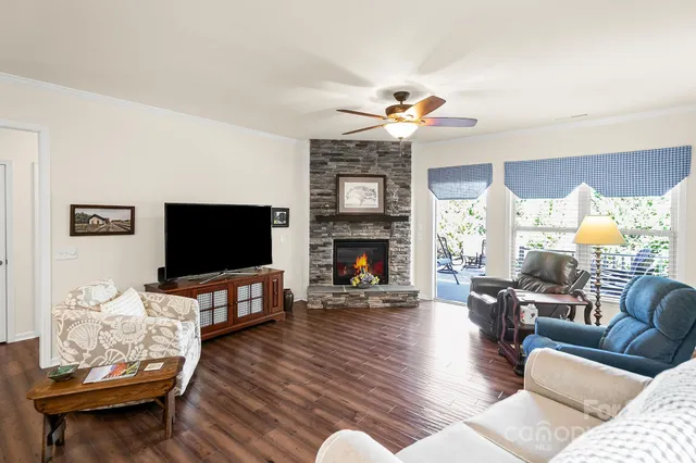 a living room with furniture flat screen tv and a fireplace