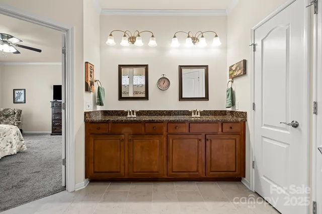 a bathroom with a granite countertop mirror and a sink