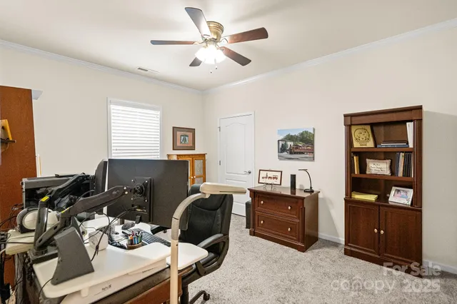 a bedroom with a workspace and a window