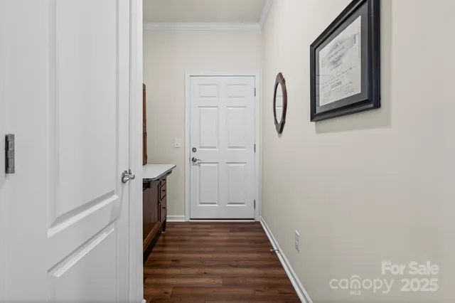 a view of a hallway with wooden floor and entryway