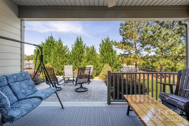 a view of balcony with chairs and wooden floor