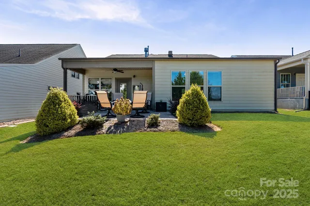 a view of a house with backyard sitting area and garden