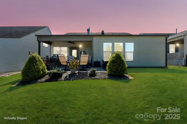 a view of a house with backyard and porch