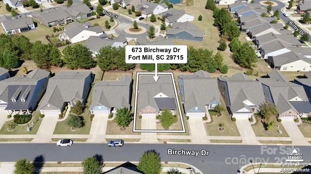 an aerial view of residential houses with outdoor space and street view