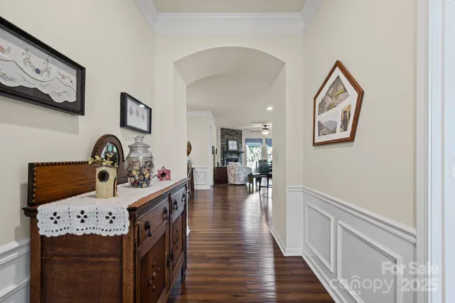 a view of a hallway to dining room with wooden floor