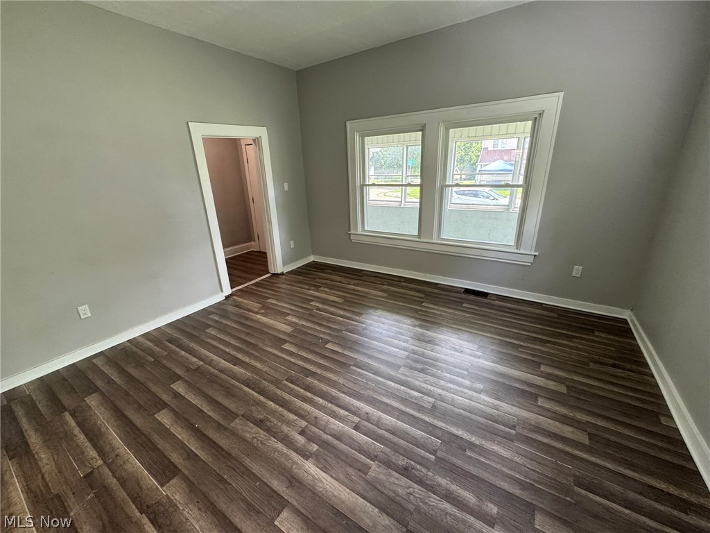 674-676 Carlysle Street Akron, OH 44310 - Photo 2 of 20 Large living room with luxury vinyl tile and double pane vinyl windows