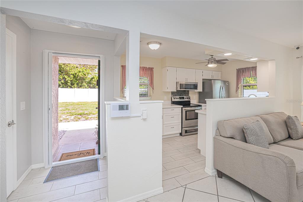 24540 Harbor View Road, Unit D3 Punta Gorda, FL 33980 - Photo 7 of 33 a living room with stainless steel appliances granite countertop a refrigerator and a stove top oven