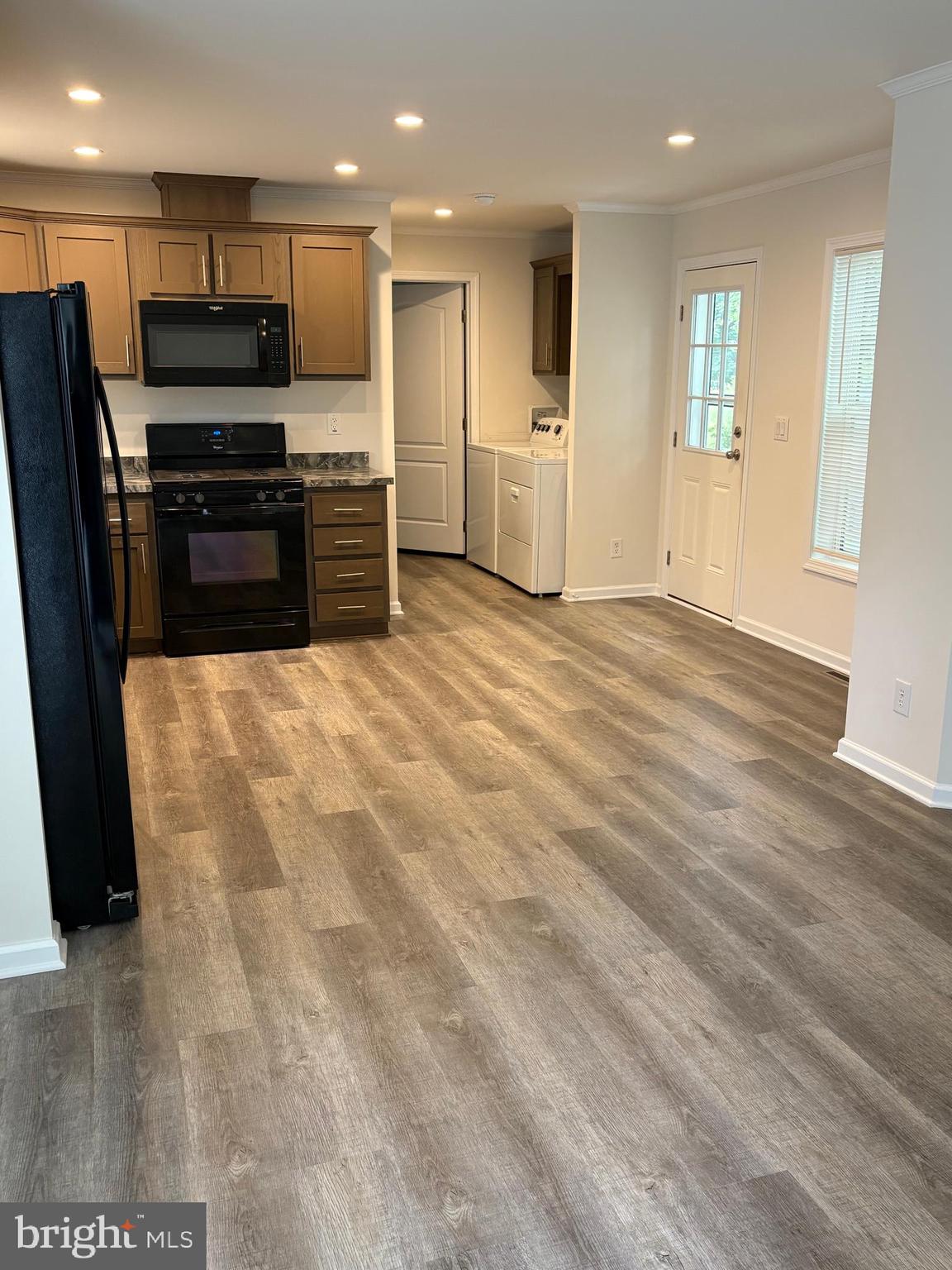 68 Friars Lane, Unit 68 Hartly, DE 19953 - Photo 5 of 18 a view of kitchen with refrigerator stove and wooden floor