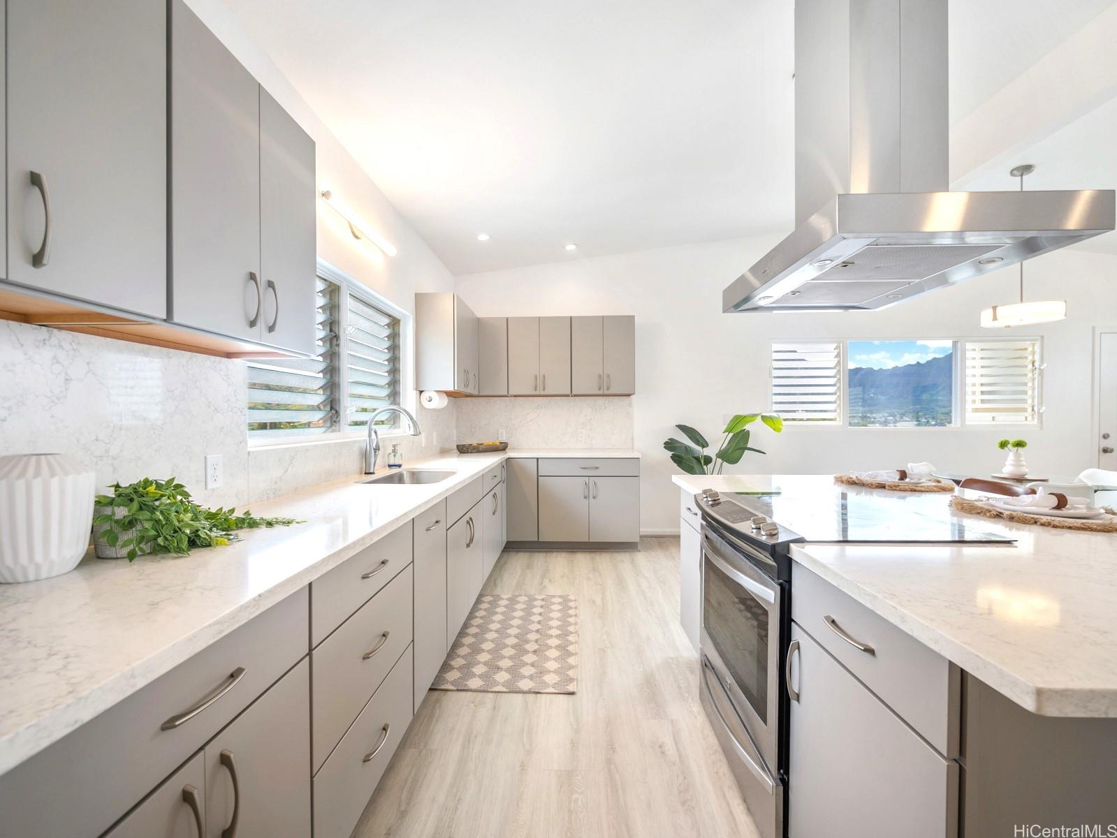 45-185 Lilipuna Road, Unit A Kaneohe, HI 96744 - Photo 1 of 1 a kitchen with a sink dishwasher stove and white cabinets