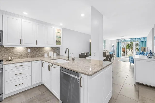 a kitchen with sink cabinets and living room