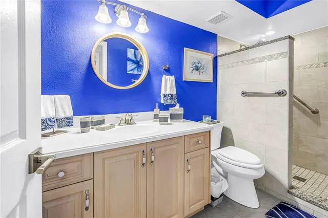 a view of a swimming pool with a lounge chair and palm trees