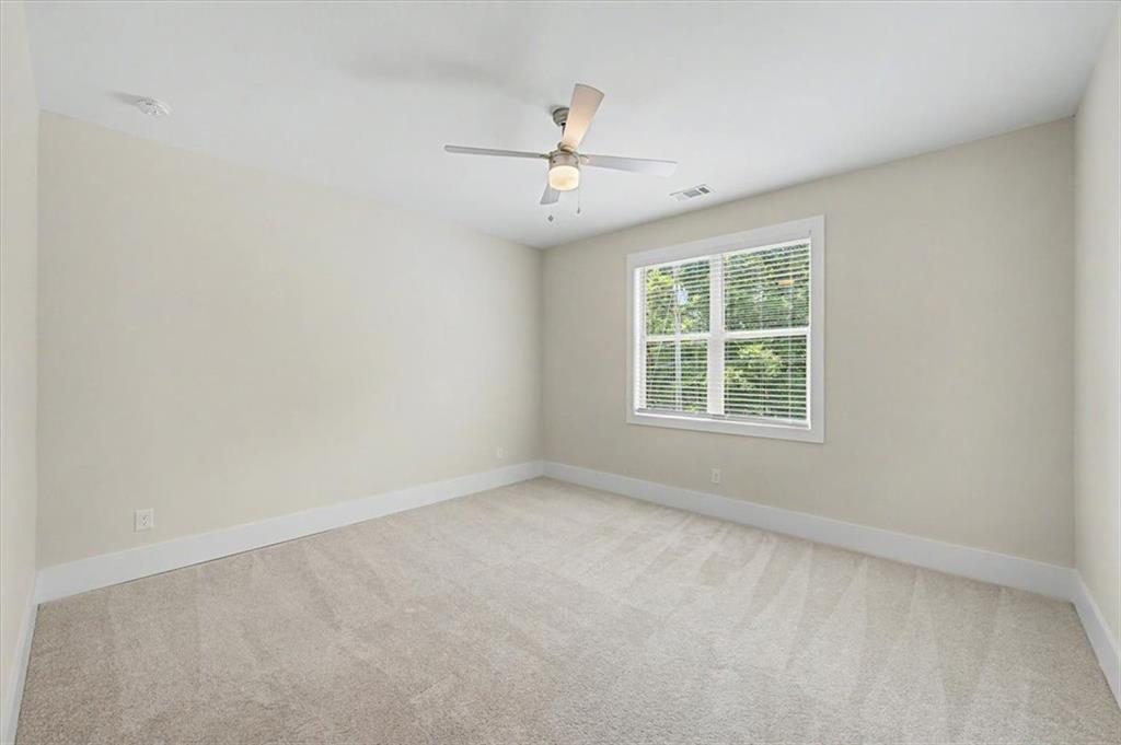 217 Laura Lake Road Marietta, GA 30066 - Photo 38 of 54 an empty room with a window and a ceiling fan