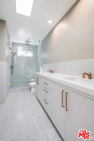 a bathroom with a bathtub a toilet and a shower