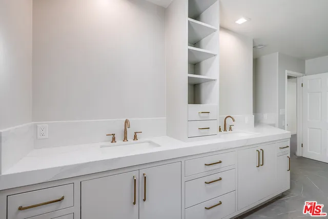 a bathroom with a double vanity sink and mirror
