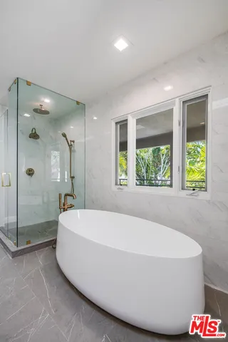 a bathroom with a bathtub and a shower