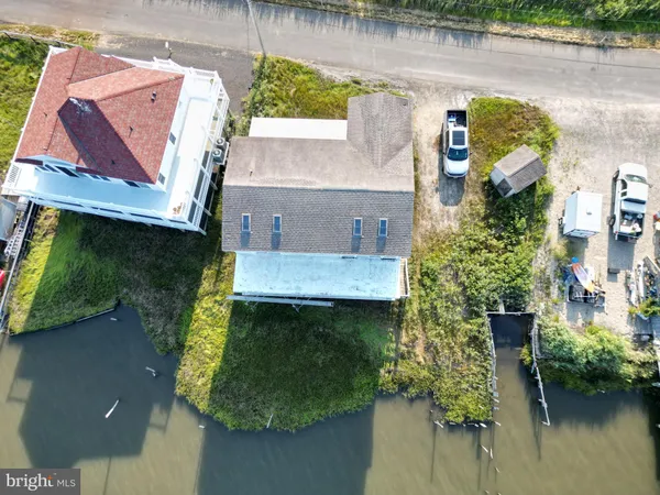 an aerial view of residential house with outdoor space and lake view
