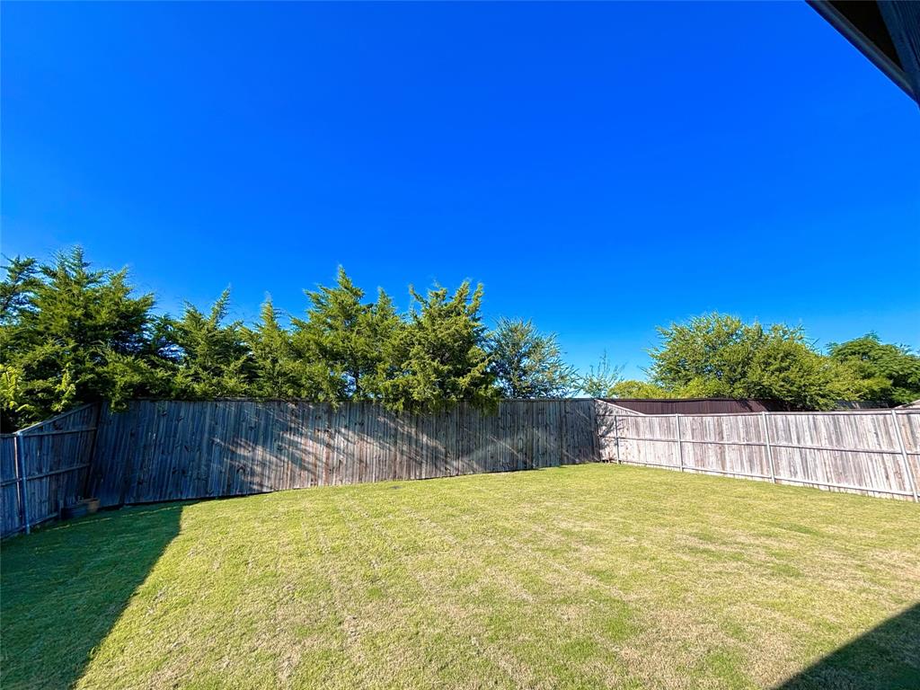 556 England Street Fate, TX 75189 - Photo 14 of 14 a view of a yard with swimming pool and wooden fence